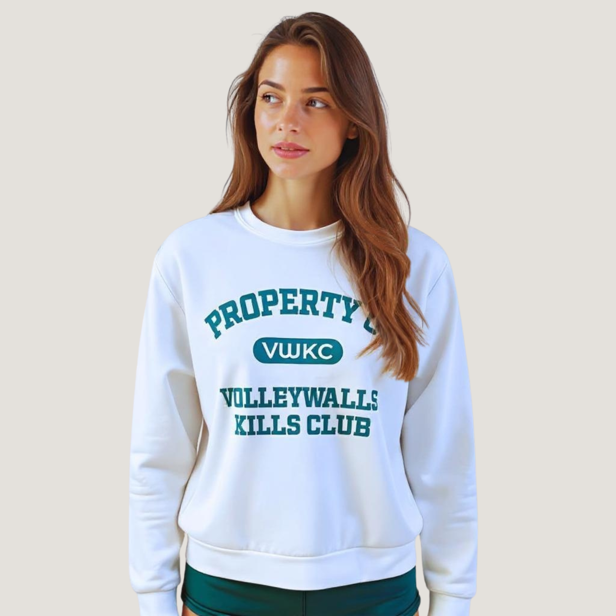 Female wearing a white sweatshirt with "Property of VolleyWalls Kills Club" text in dark green across the front
