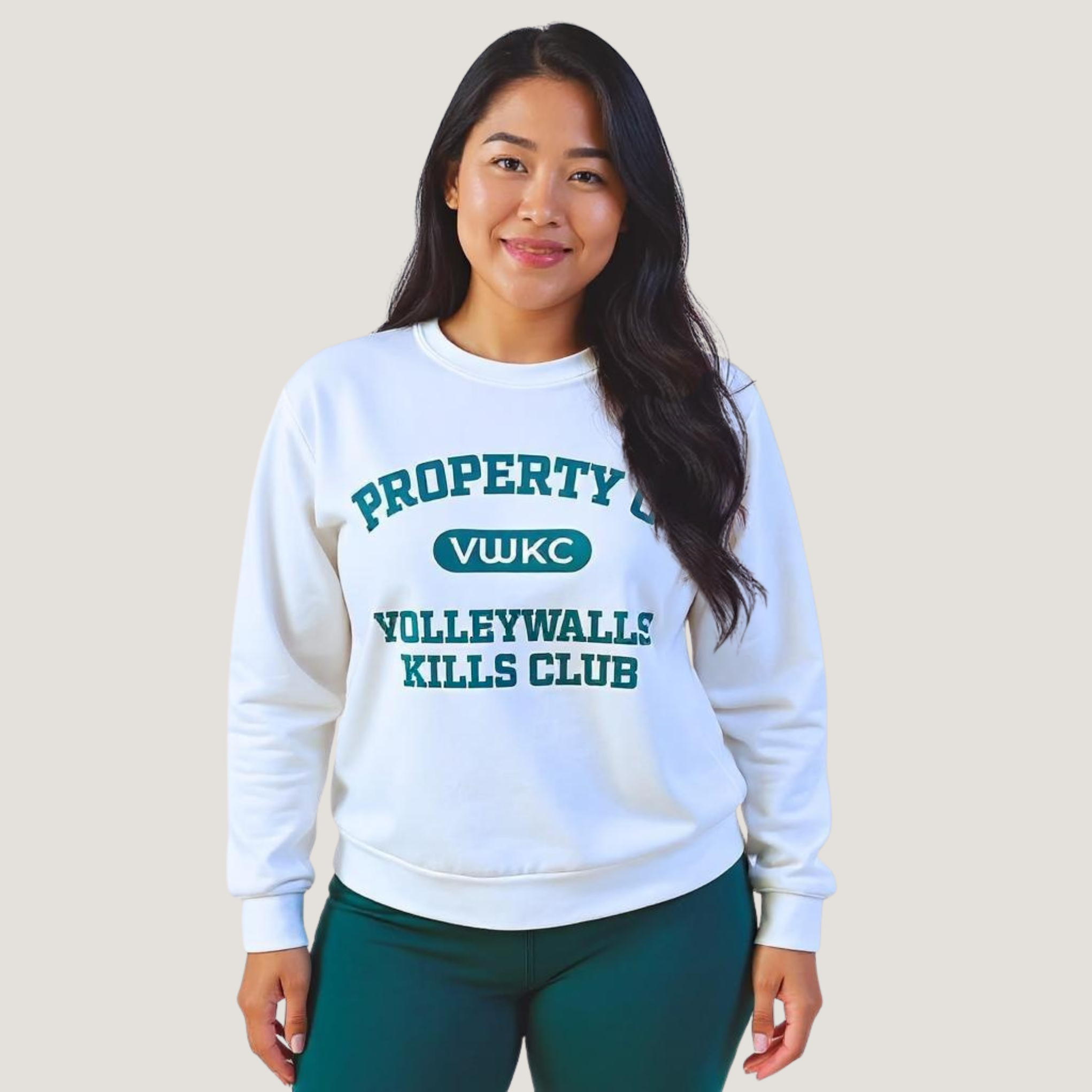 Female wearing a white sweatshirt with "Property of VolleyWalls Kills Club" text in dark green across the front
