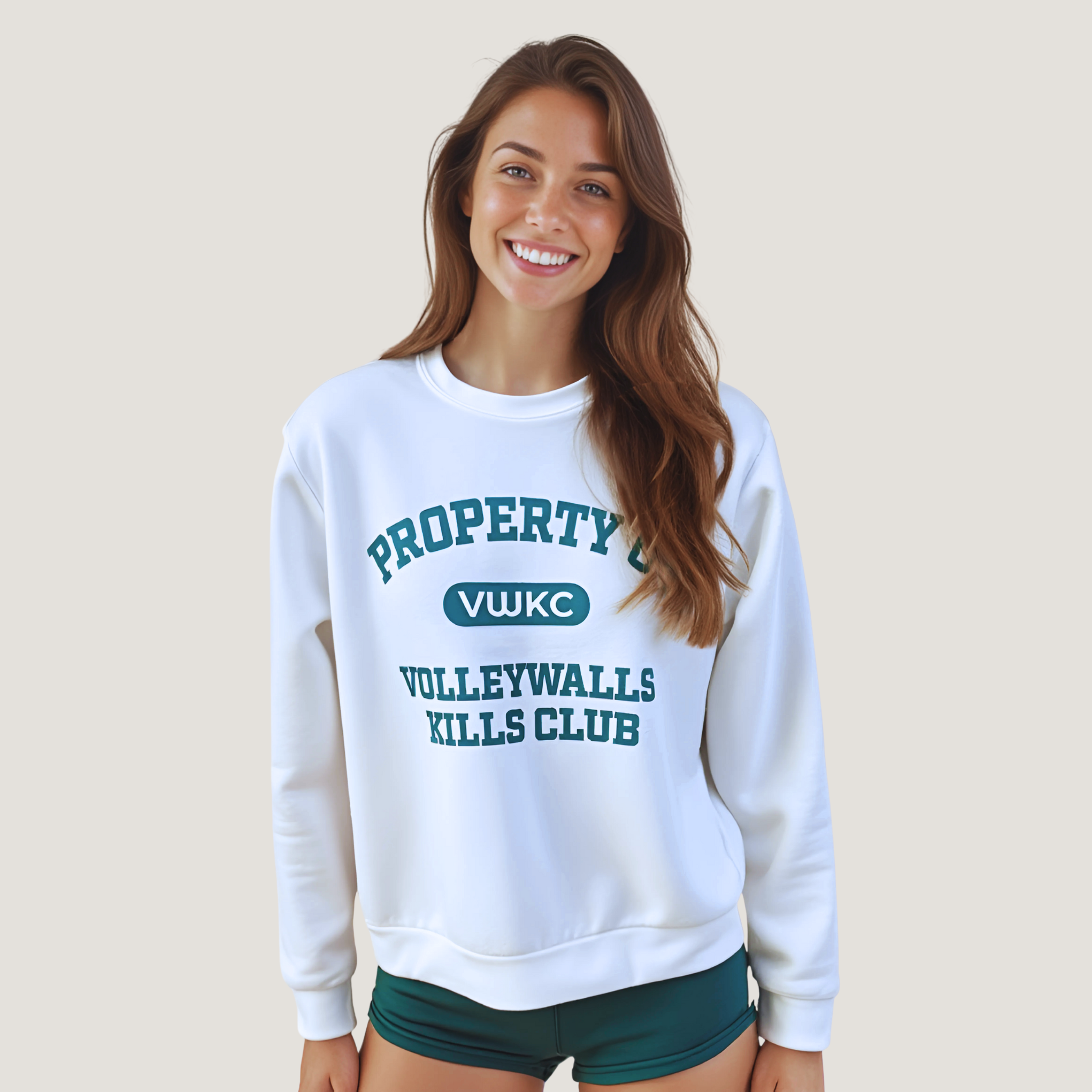 Female wearing a white sweatshirt with "Property of VolleyWalls Kills Club" text in dark green across the front 