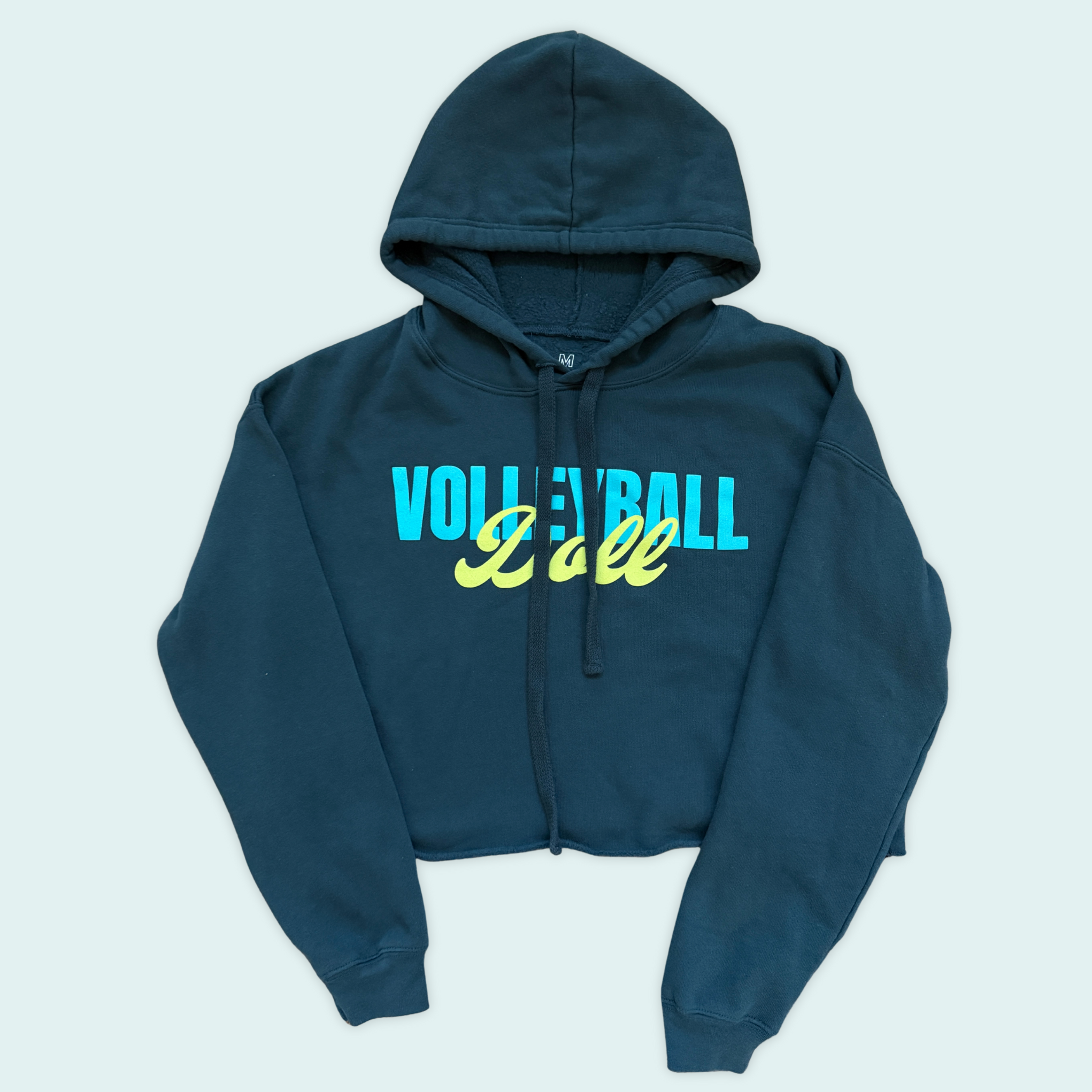 Blue-green cropped hoodie with 'Volleyball Doll' text in bright light blue and yellow-green text across the front 
