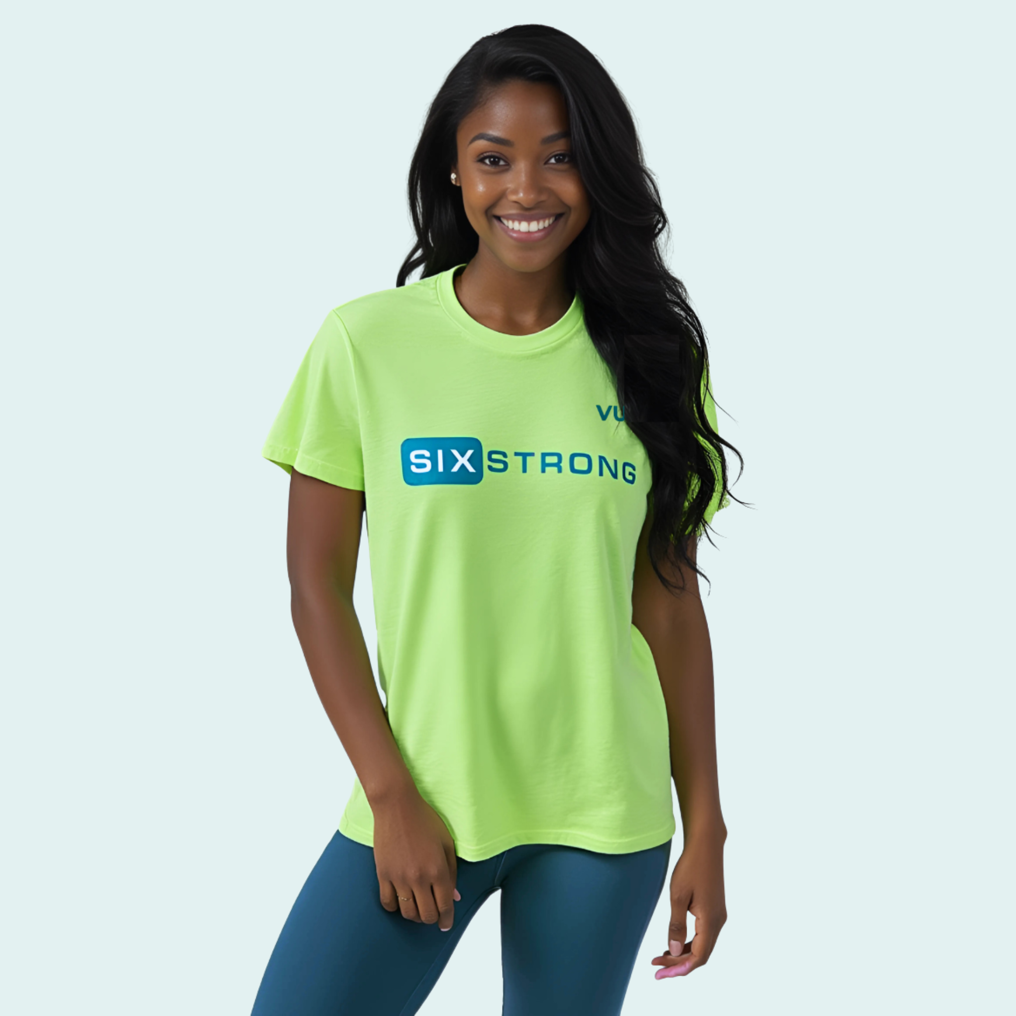 Female wearing a lime green-yellow t-shirt with dark green 'Six Strong' t-text across the front and a dark green VW logo on left chest
