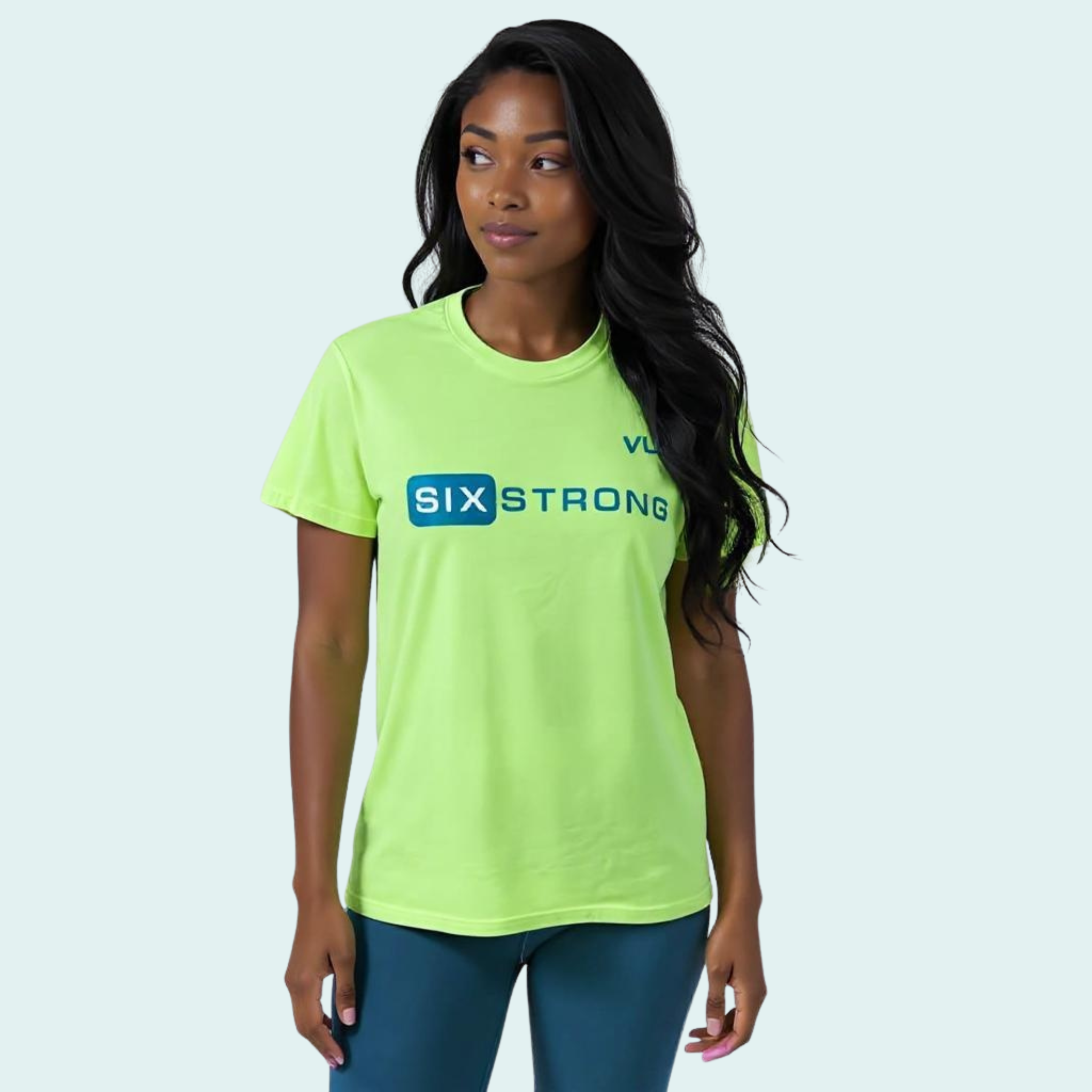 Female wearing a lime green-yellow t-shirt with dark green 'Six Strong' t-text across the front and a dark green VW logo on left chest